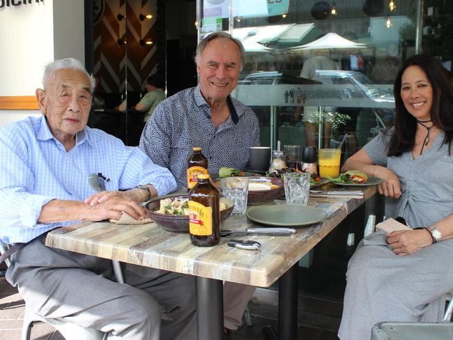 John Alexander with his partner Deb and her father Dr Desmond Hing enjoying a meal at Putney’s Café Dolcini.