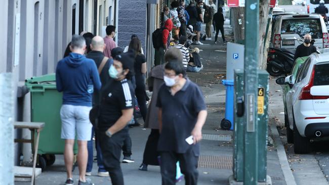 A long queue forms outside the Darlinghurst Centrelink office. Picture: Rohan Kelly