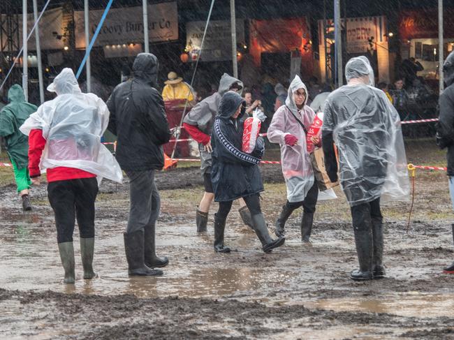 BYRON BAY, AUSTRALIA - JULY 22: Festivalgoers are seen in the rain and the mud at Splendour in the Grass 2022 on July 22, 2022 in Byron Bay, Australia.  (Photo by Marc Grimwade/WireImage)