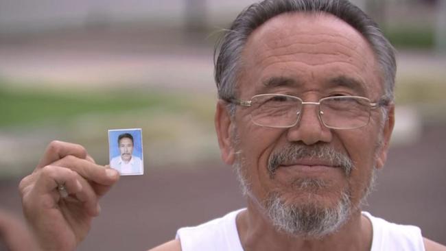 Released detainee Aliyawar Yawari outside the Perth City Motel Thornlie, in Perth’s east. Yawari is holding the picture of himself taken prior to being placed in detention. Picture: Seven News