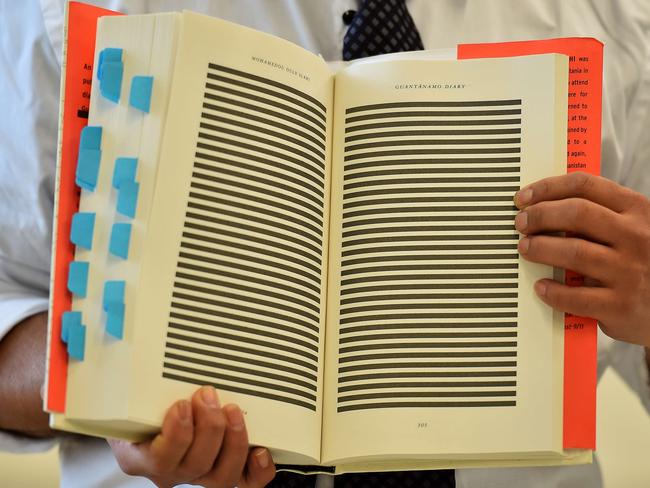 The younger brother of Mohamedou Ould Slahi, Yahdih Ould Slahi poses with a copy of Mohamedou's prison memoir 'Guantanamo Diary'. Picture: Ben Stansall / AFP