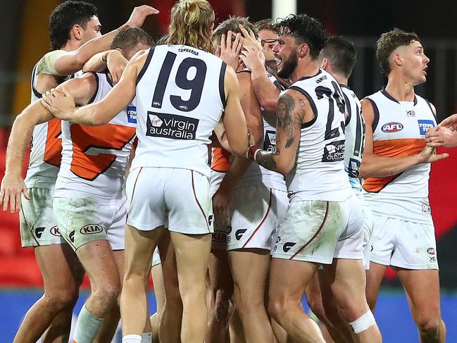 Callan Ward is congratulated by teammates after his winning goal.