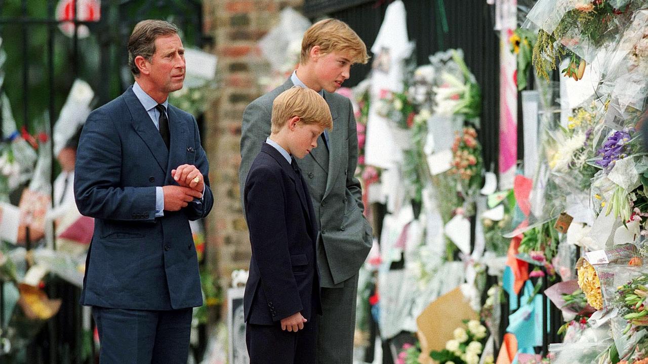 Charles, Prince William and Prince Harry look at floral tributes to Diana outside Kensington Palace. (Photo by Anwar Hussein/WireImage)