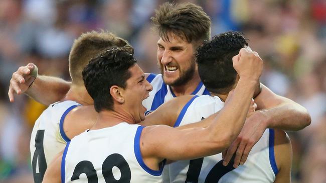 MELBOURNE, AUSTRALIA - SEPTEMBER 13: Jarrad Waite of the Kangaroosis congratulated by team mates after kicking a goal during the First AFL Elimination Final match between the Richmond Tigers and the North Melbourne Kangaroos at Melbourne Cricket Ground on September 13, 2015 in Melbourne, Australia. (Photo by Quinn Rooney/Getty Images)