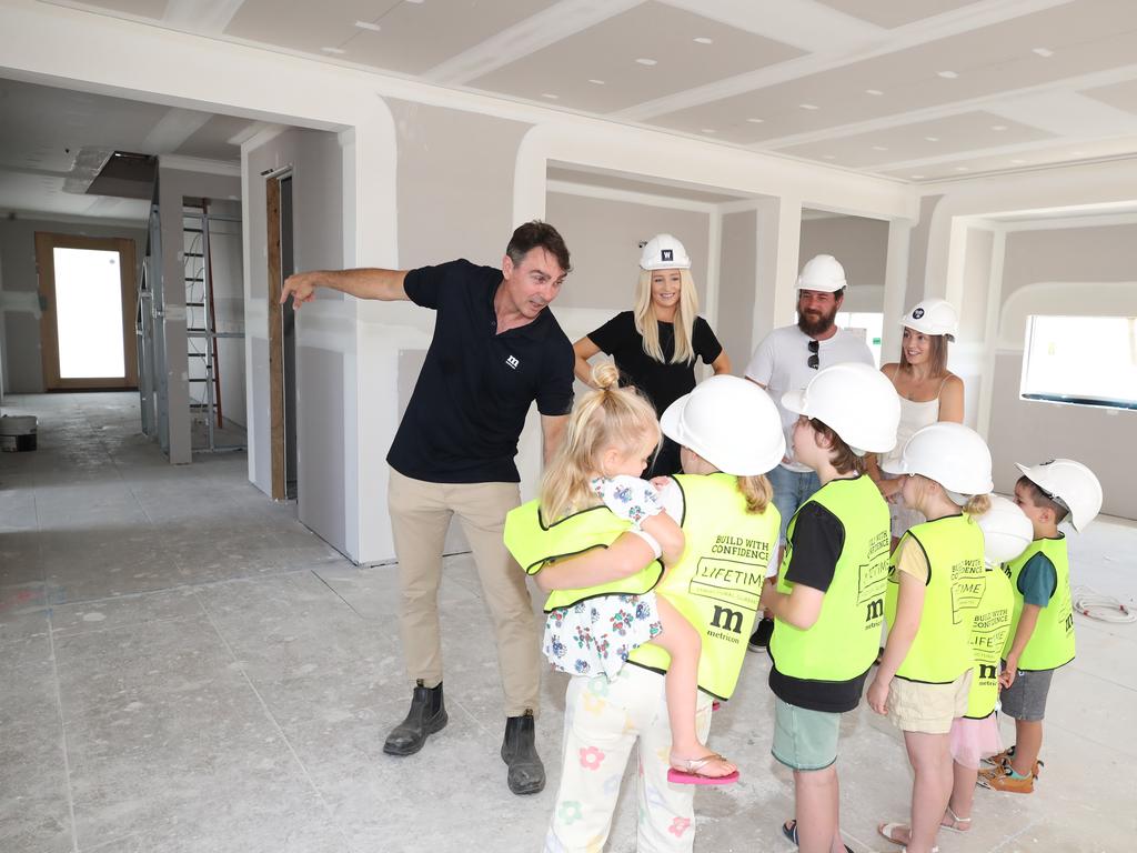 The children enjoy the walk-through of their new home. Picture Glenn Hampson