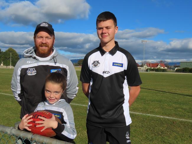 Scottsdale senior men's coach Joel Hayes with daughter and under-11s player Mila, 8, and recent seniors debutant Lochie Bowerman at the club's grounds on Tuesday. Picture: Jon Tuxworth