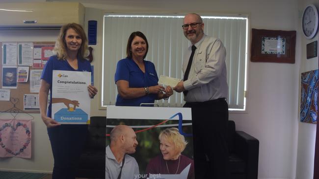 GIVING SEASON: Commonwealth Bank Biloela manager Jason Spence handing the donation to Anglicare CQ's Deborah Vonhoff and Lori Simpkins.