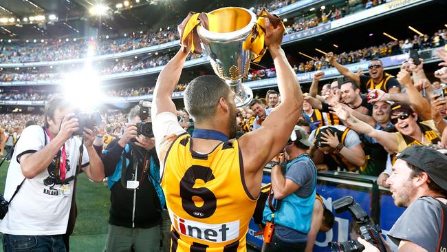 Hawthorn's Josh Gibson celebrates with the trophy after the 2014 AFL Grand Final match between Hawthorn Hawks and the Sydney Swans at the MCG Melbourne Cricket Ground on September 27, 2014. Picture: Wayne Ludbey