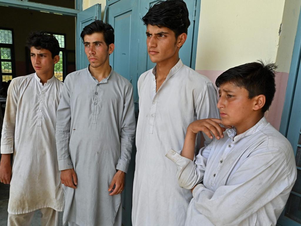 Survivors of the cable car accident speak to a professor at their school – a day after being rescued from a chairlift that plunged into a ravine. Picture: Farooq Naeem/AFP