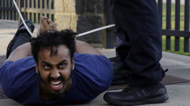 A demonstrator is detained by Atlanta Police.