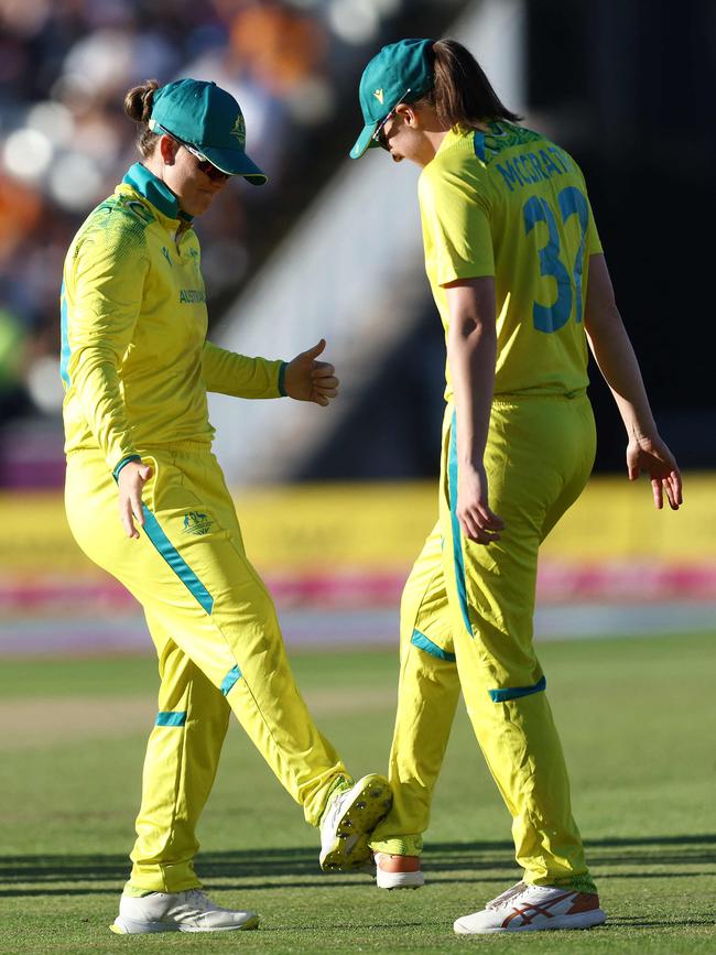 Jess Jonassen and Tahlia McGrath have a Covid-safe wicket celebration. Picture: Darren Staples / AFP