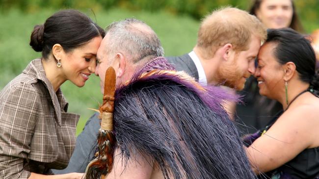 Nice to nose you ... Harry and Meghan attend a traditional welcome ceremony on the lawns of Government House in Wellington, yesterday. Picture: Nathan Edwards