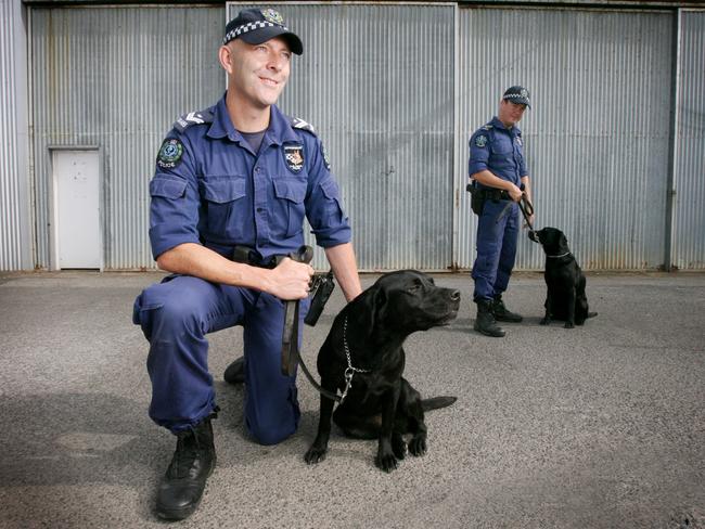 Senior constables Nic Whiteside and Dan Lacey with drug-detecting dogs Carli Tilley.