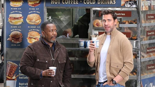 John Krasinski right, with Wendell Pierce) in a cardigan on the set of 