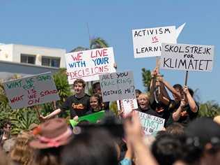 STRIKE FORCE: Students wave their banners high. Picture: Elliot Kirkwood