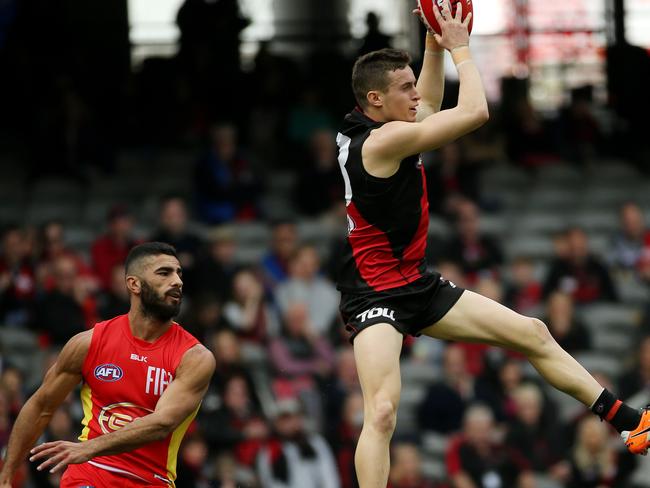 Orazio Fantasia takes a mark in front of Gold Coast’s Adam Saad. Picture: Colleen Petch