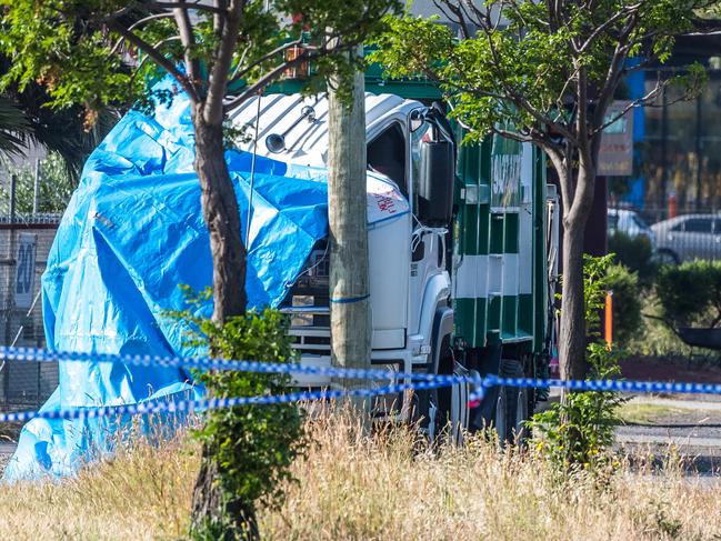 Fatal crash involving two trucks in Epping. A tarp covers the cabin of the truck from which the driver was thrown. Picture: Jake Nowakowski