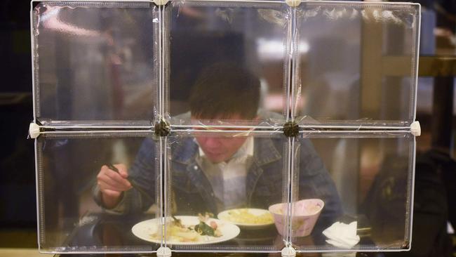 A restaurant separating diners with table partitions as a preventive measure against the COVID-19 coronavirus in Ningbo, in eastern China's Zhejiang province. Picture: AFP