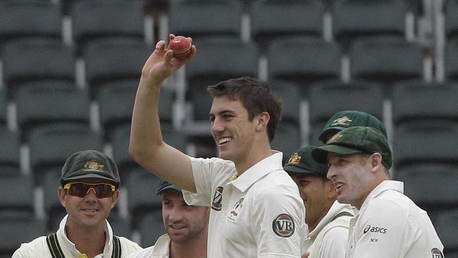 Australia's bowler Pat Cummins, center, with teammates celebrates after dismissing South Africa's batsman Vernon Philander, unseen, for 23 runs on the fourth day of the second test cricket match at the Wanderers stadium in Johannesburg, South Africa, Sunday, Nov. 20, 2011. (AP Photo/ Themba Hadebe)