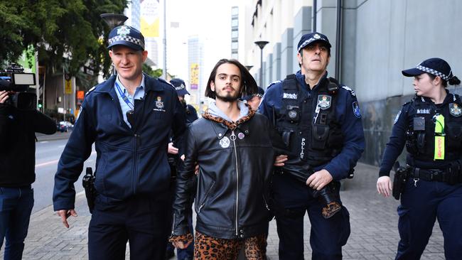 Environmental activist Eric Herbert is arrested during an Extinction Rebellion protest in the central business district of Brisbane. Picture: AAP Image/Dave Hunt