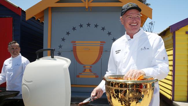 International team captain Ernie Els cooks up some sausages at Brighton Beach ahead of the Presidents Cup. Picture: Michael Klein