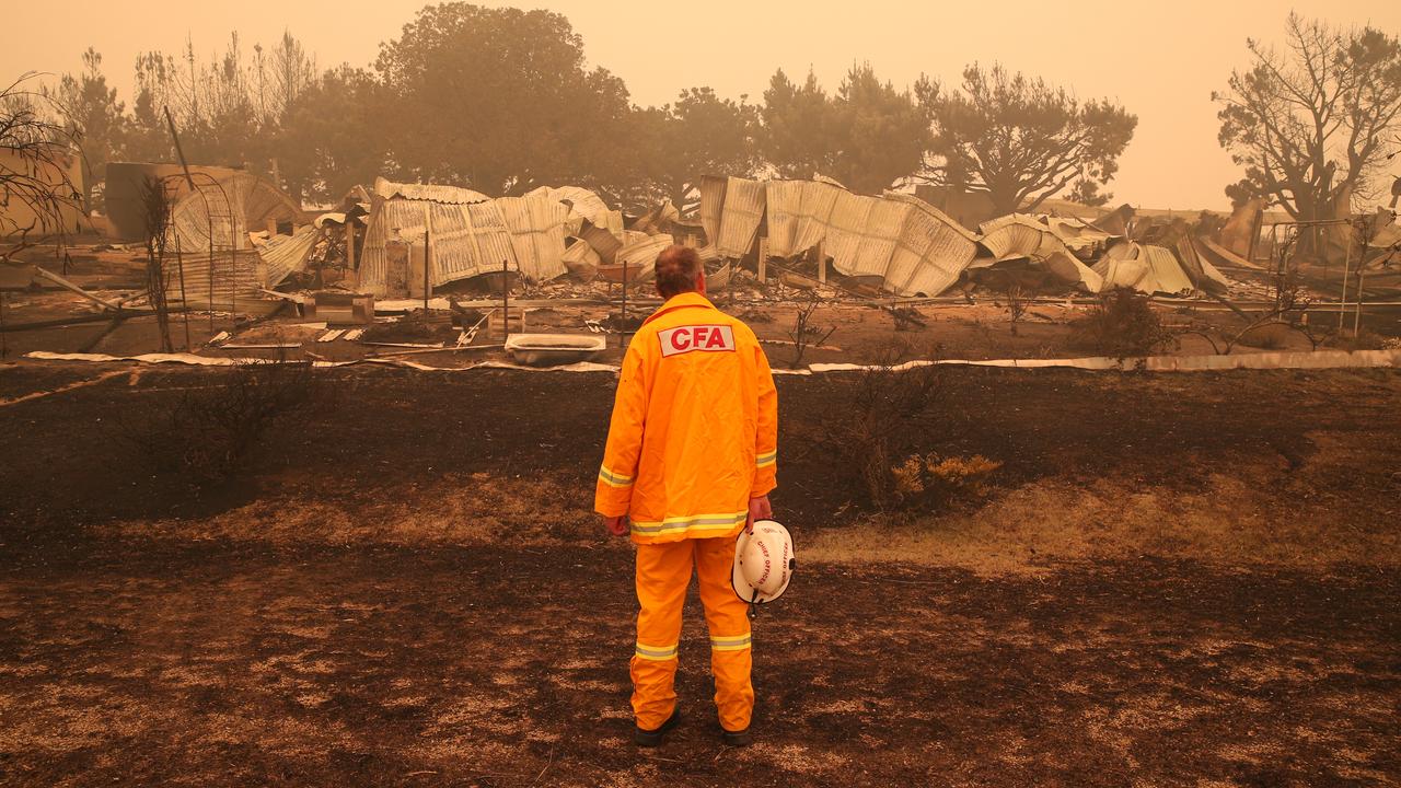 CFA fire chief Steve Warrington looks at a destroyed house in Buchan in the fires on Friday, January 3. Picture: David Crosling