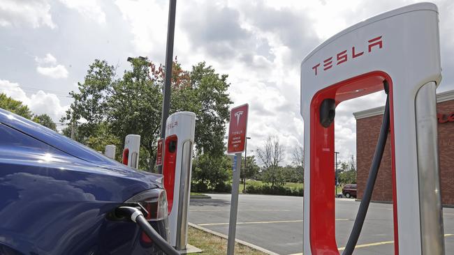 A Tesla vehicle charges at a Tesla supercharger site in the United States. Picture: Chuck Burton/AP