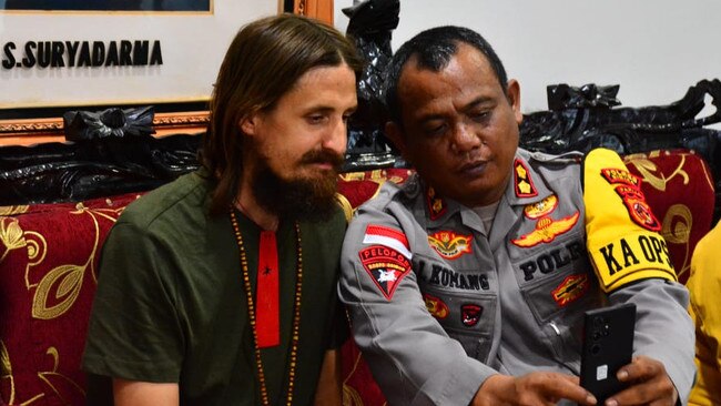 NZ pilot Phillip Mehrtens with Indonesian police and security officials from Operation Peaceful Cartenz at police HQ in Timika after his release.