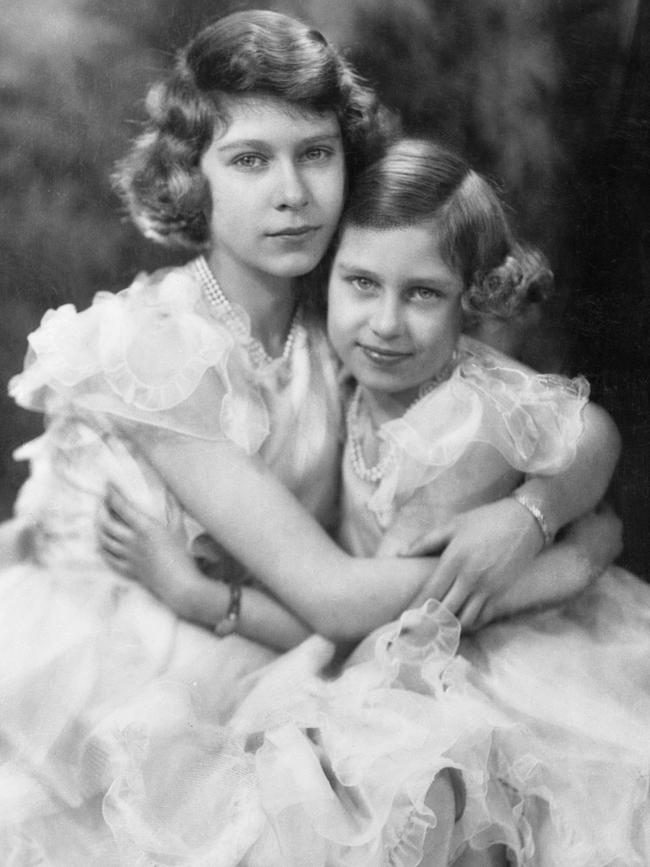 Elizabeth poses with her nine-year-old sister for her 14th birthday portrait in April 1940. Some months earlier, aged just 13, she met the man who would be her future husband for the first time, reportedly describing the 18-year-old Philip as looking “like a Viking god”. Picture: Getty