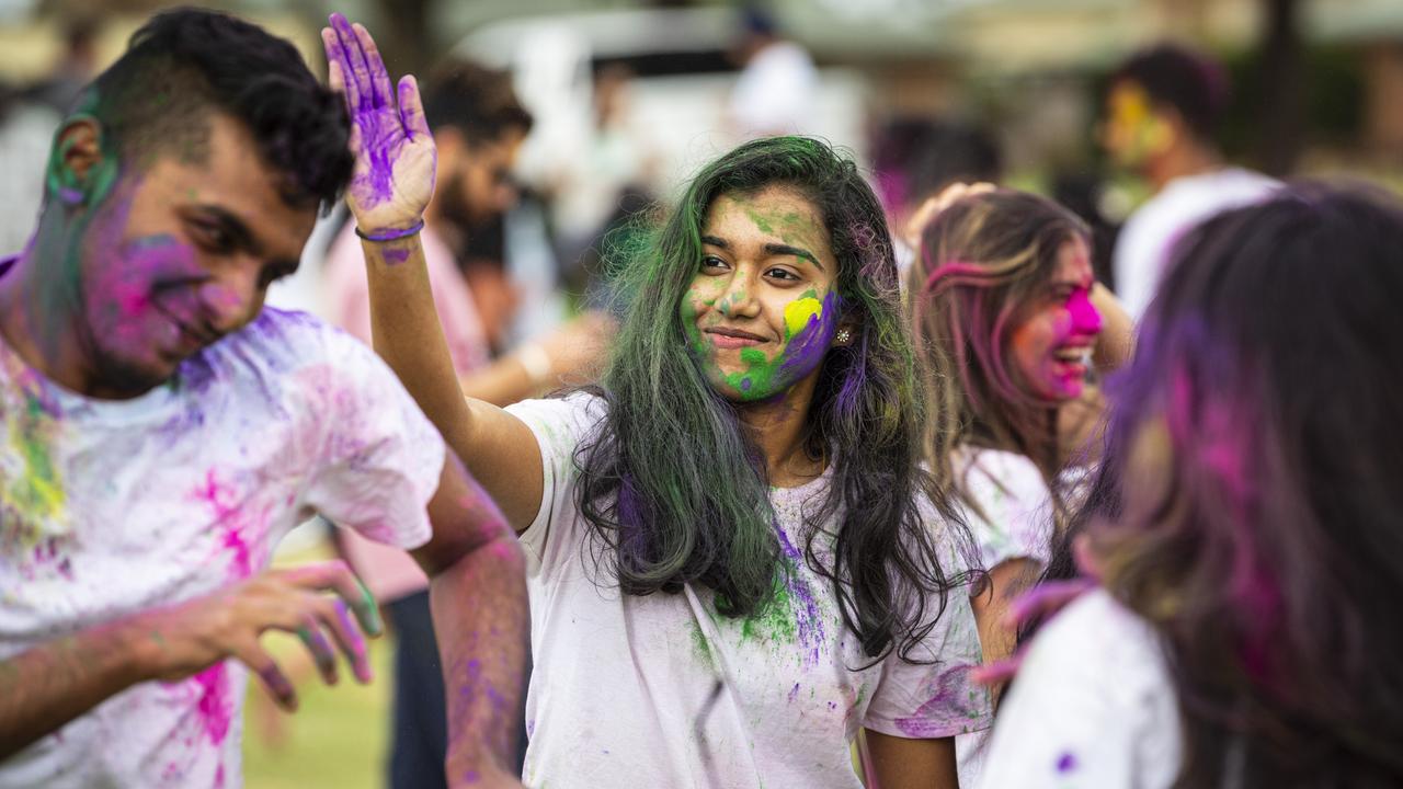 Ann Mary Sunil looks to colour Don Thomas as the Toowoomba Indian and Nepalese communities celebrate Holi, the festival of colours, Saturday, March 23, 2024. Picture: Kevin Farmer