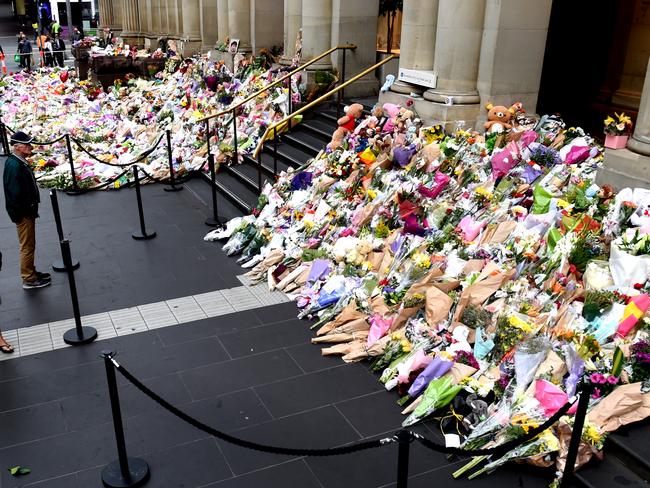 Flower tributes on the corner of Bourke and Elizabeth streets on Tuesday. Picture: Nicole Garmston