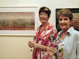 WILL BE MISSED: Alison Iszlaub (left) and Jill Copeland admiring the artwork on display at the Wondai Art Gallery in 2012. Picture: Rowan Hunnam