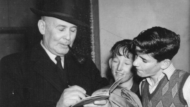 An eye to the future: Ben Chifley signs an autograph book for Phil Baird in the 1940s. Picture: Courtesy Phil Baird