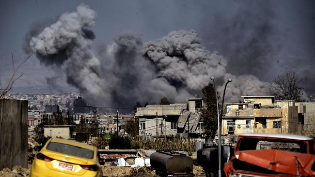 Smoke plumes rise after an airstrike in west Mosul on March 10. Picture: AFP/Aris Messinis