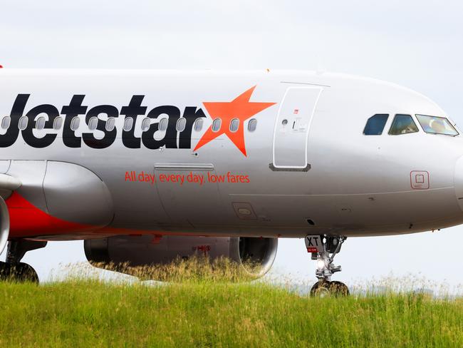 SYDNEY, AUSTRALIA - JANUARY 20: The nose of a Jetstar plane at Sydney Airport on January 20, 2024 in Sydney, Australia. Transport Minister Catherine King signed off on a deal that will allow Turkish Airlines to start serving the Australian market, rising to 35 flights a week by 2025. The decision came as the government was under mounting criticism from many for a perception that it was protecting the profits of Qantas and stymying competition in the market by limiting additional capacity for other carriers, such as Qatar Airways. (Photo by Jenny Evans/Getty Images)