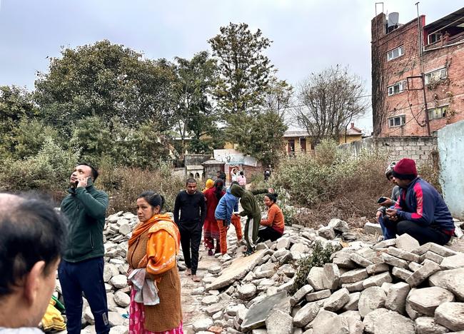 People gather in an open area of Nepal's capital Kathmandu after feeling the powerful tremor in neighbouring Tibet