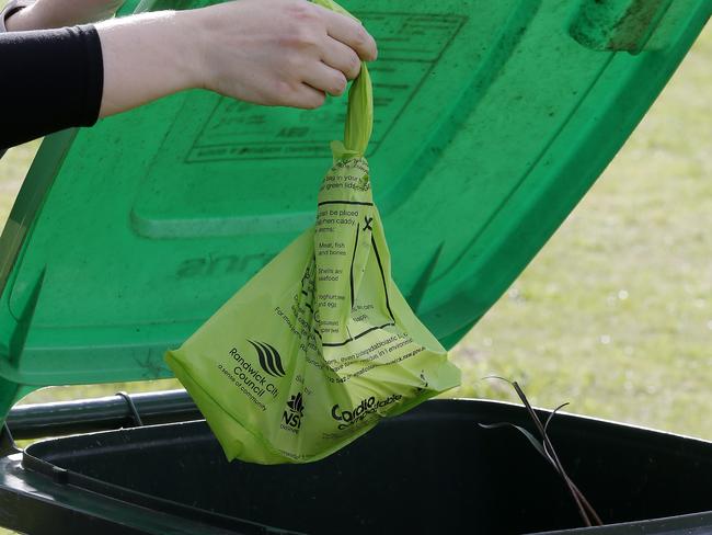 a Compostable bag for household food scraps , that is biodegradable. being deposited in a Randwick Council FOGO Bin (Food organics and Garden Organics).   Picture: John Appleyard