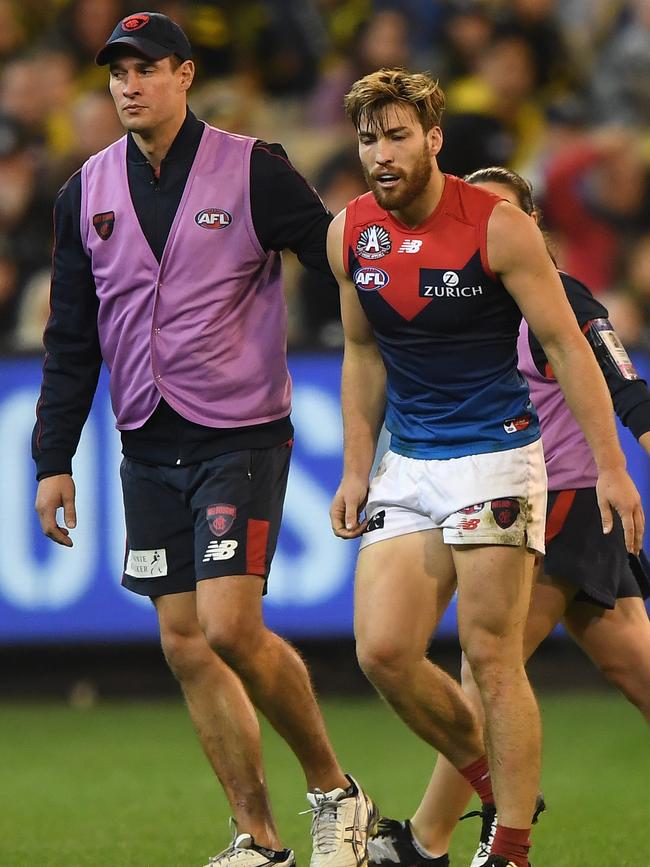 Captain Jack Viney is helped from the field after being injured last season.