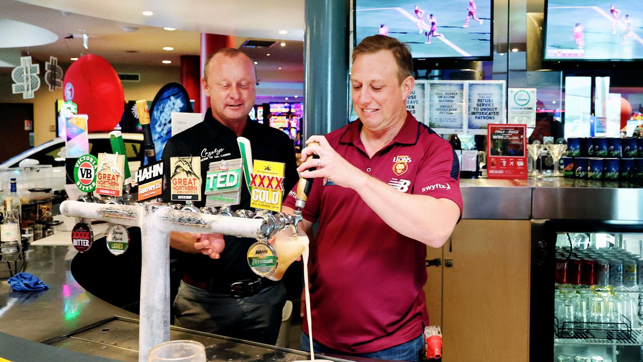 Queensland Premier Steven Miles pours a frothy one off the tap at Cazalys Sports Club, at half time AFL Grand Final. Picture: Brendan Radke