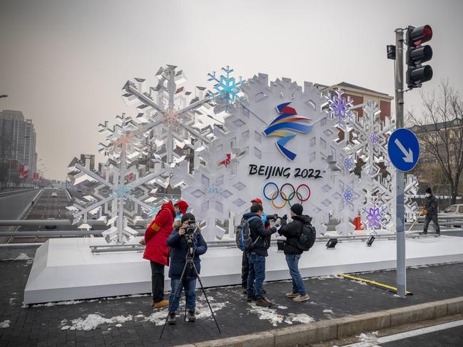 People stand in front of a sculpture about Beijing 2022 Winter Olympics on January 23, 2022 in Beijing, China. Picture: Andrea Verdelli/Getty Images