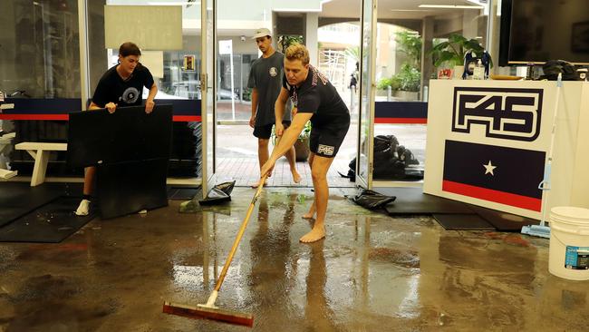 Tim Menzies sweeping out the F45 Gym on Central Ave in Manly soon after it was flooded on Tuesday. Picture: Tim Hunter.