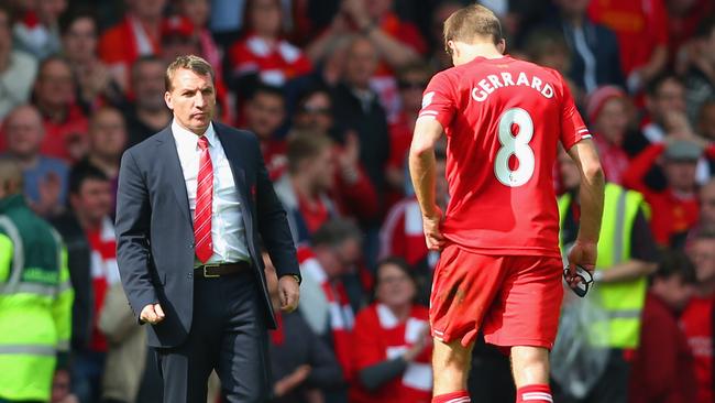 Manager Brendan Rodgers of Liverpool looks to dejected skipper Steven Gerrard.