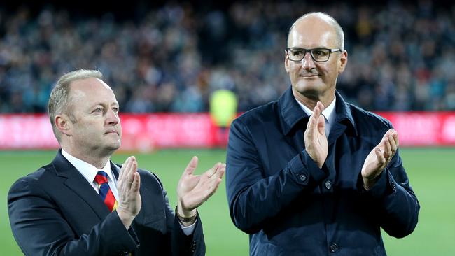 Crows chairman Rob Chapman and Port Adelaide president David Koch come together at a tribute for the late Phil Walsh in 2015. Picture: Calum Robertson