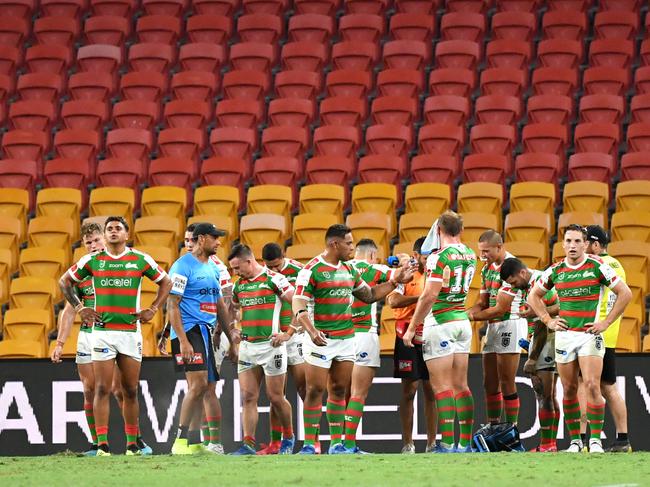 Souths players are seen in front of empty grandstands during the round two NRL match between the Brisbane Broncos and South Sydney Rabbitohs at Suncorp Stadium in Brisbane, Friday, March 20, 2020. (AAP Image/Darren England) NO ARCHIVING, EDITORIAL USE ONLY