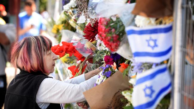 Well wishers continue to put flowers and messages of support on fencing encircling the temple. Picture: NewsWire / Andrew Henshaw