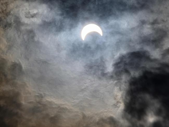 The moon covers the sun in a rare "ring of fire" solar eclipse as seen from Bangkok on December 26, 2019. (Photo by Mladen ANTONOV / AFP)