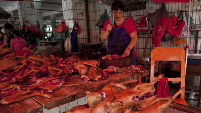 A butcher prepares cuts of dog meat for sale in Yulin, in southern China’s Guangxi province, where the city’s annual Dog Meat Festival is underway despite international criticism. Picture: AFP