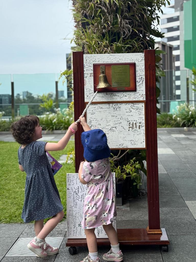 Millie invited her little sister Evelyn to ring the bell, signifying the end of her treatment and of defying cancer on January 24. Photo: Courtney Barrett