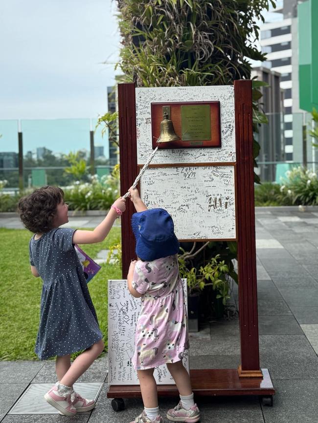 Millie invited her little sister Evelyn to ring the bell, signifying the end of her treatment and of defying cancer on January 24. Photo: Courtney Clark