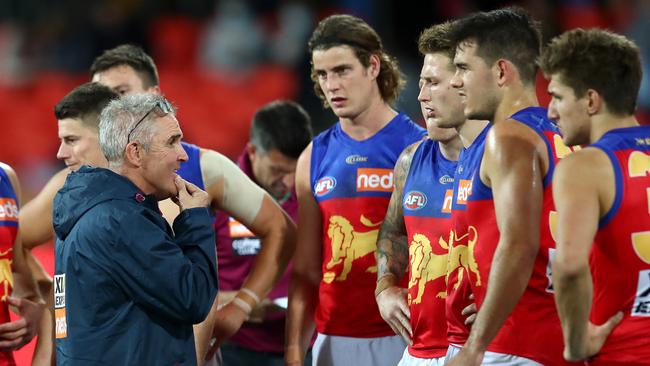 Lions coach Chris Fagan looks at a loss as he speaks to his young midfield. Picture: Jono Searle/AFL Photos